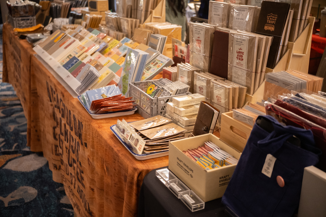 Fully stocked notebooks and other stationery at the TRAVELER'S COMPANY USA table at the California pen show.