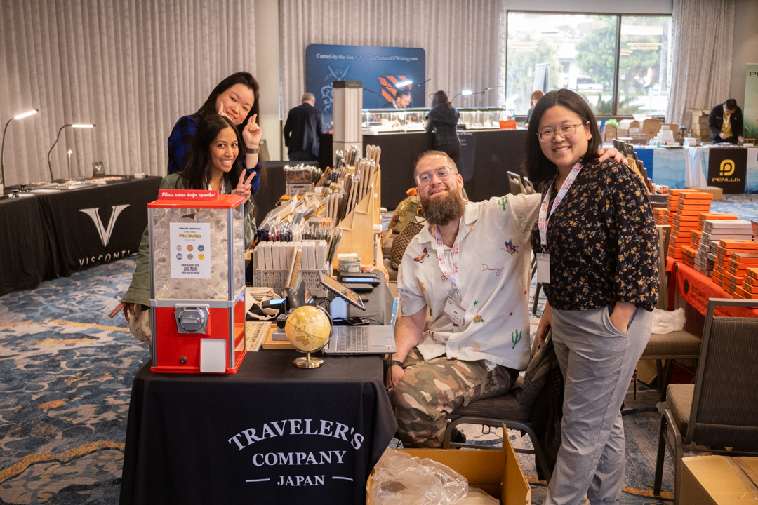 The TRC USA team posing near the TRAVELER'S COMPANY USA table at the California pen show.