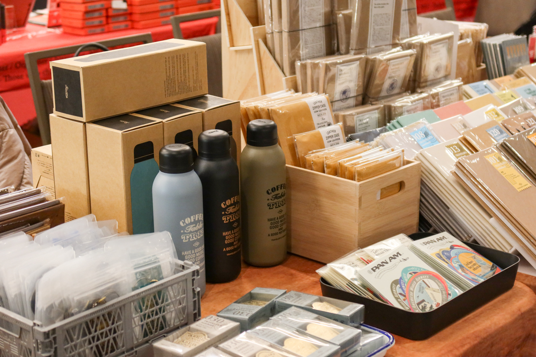 Fully stocked notebooks, bags, water bottles, and other stationery at the TRAVELER'S COMPANY USA table at the California pen show.