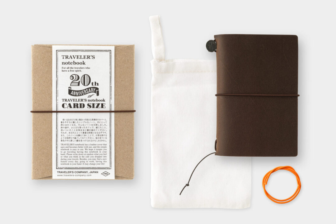 TRAVELER'S notebook Card Size Brown with cotton bag and spare rubber band.