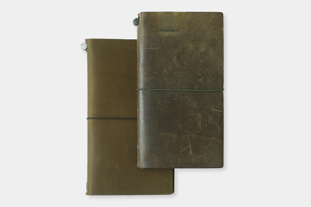 A new Olive TRAVELER'S notebook beside a used Olive TRAVELER'S notebook to showcase the patina and aging process of leather with use and time.