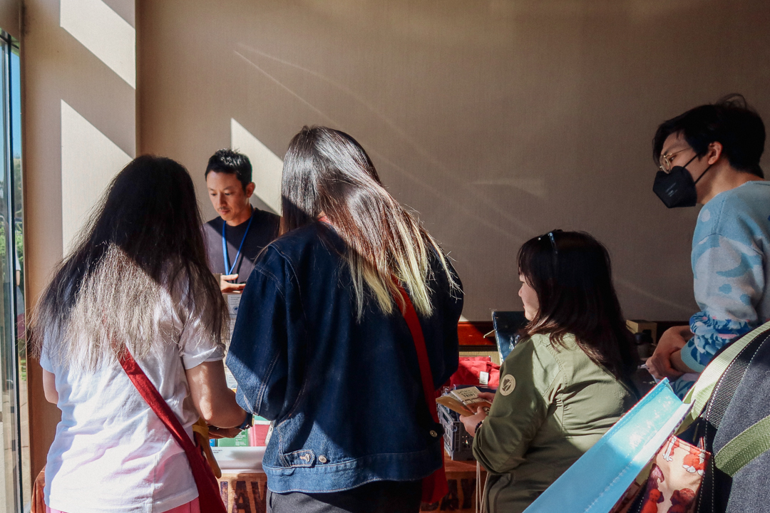 People shopping TRAVELER’S COMPANY and TRAVELER'S FACTORY items at the TRC USA table at the SF Stationery Fest.