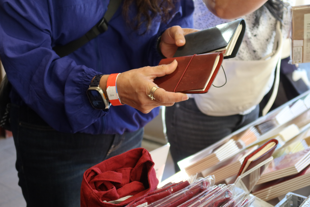 People shopping TRAVELER’S COMPANY and TRAVELER'S FACTORY items at the TRC USA table at the SF Stationery Fest.