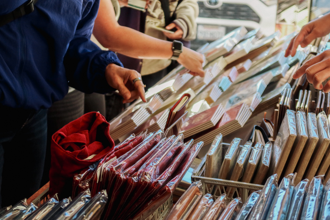 People shopping TRAVELER’S COMPANY and TRAVELER'S FACTORY items at the TRC USA table at the SF Stationery Fest.