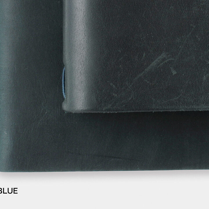 A close-up of a new Blue TRAVELER'S notebook beside a used Blue TRAVELER'S notebook to showcase the patina and aging process of leather with use and time.
