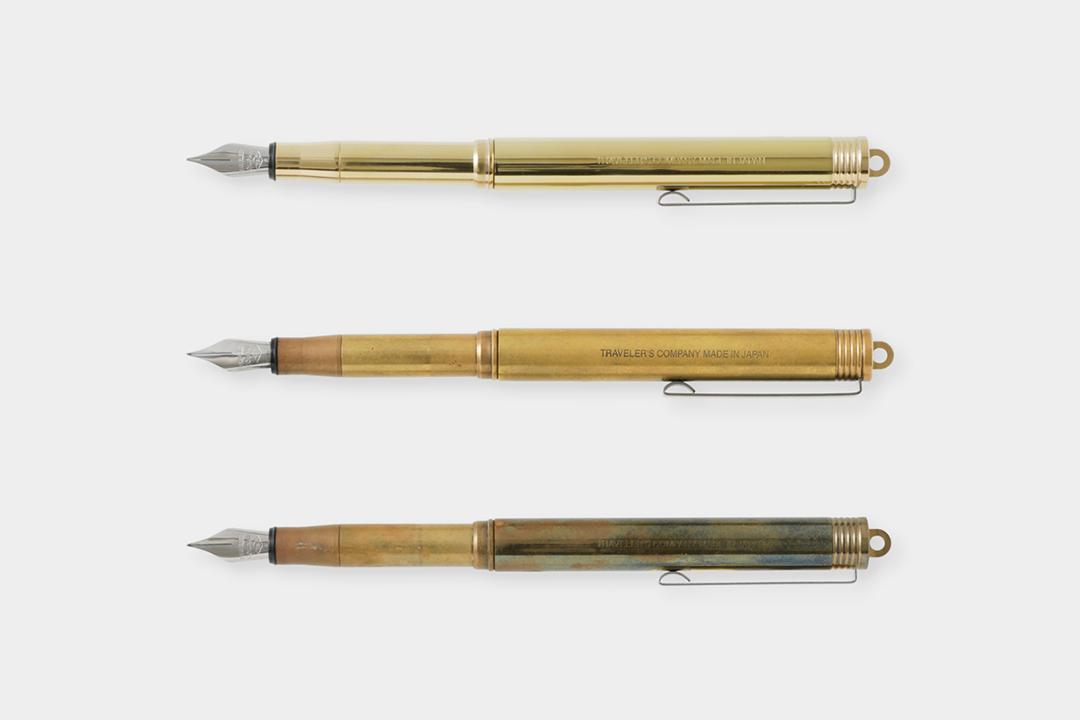 A new brass fountain pen beside a used brass fountain pen to showcase the patina and aging process of raw solid brass.