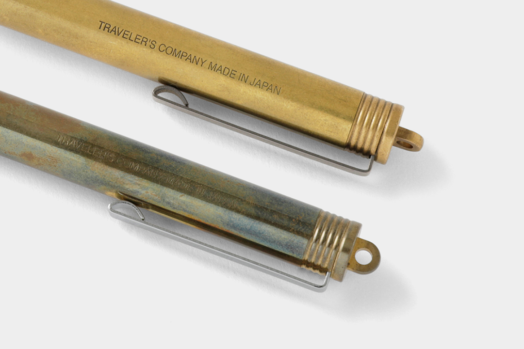 A new brass pen beside a used brass pen to showcase the patina and aging process of raw solid brass.