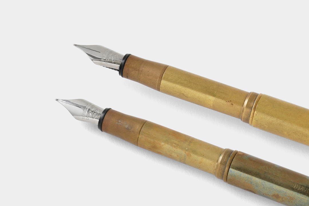 A new brass fountain pen beside a used brass fountain pen to showcase the patina and aging process of raw solid brass.