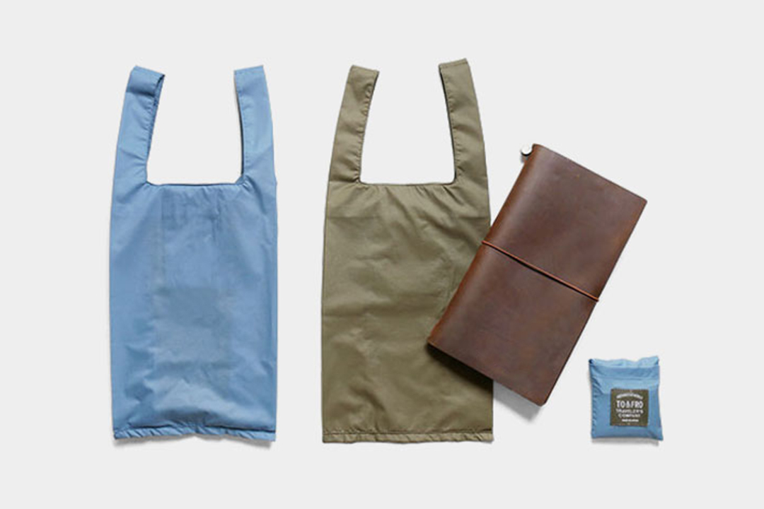 TF TO&FRO Compact Bag XS next to a TRAVELER'S notebook in Brown.