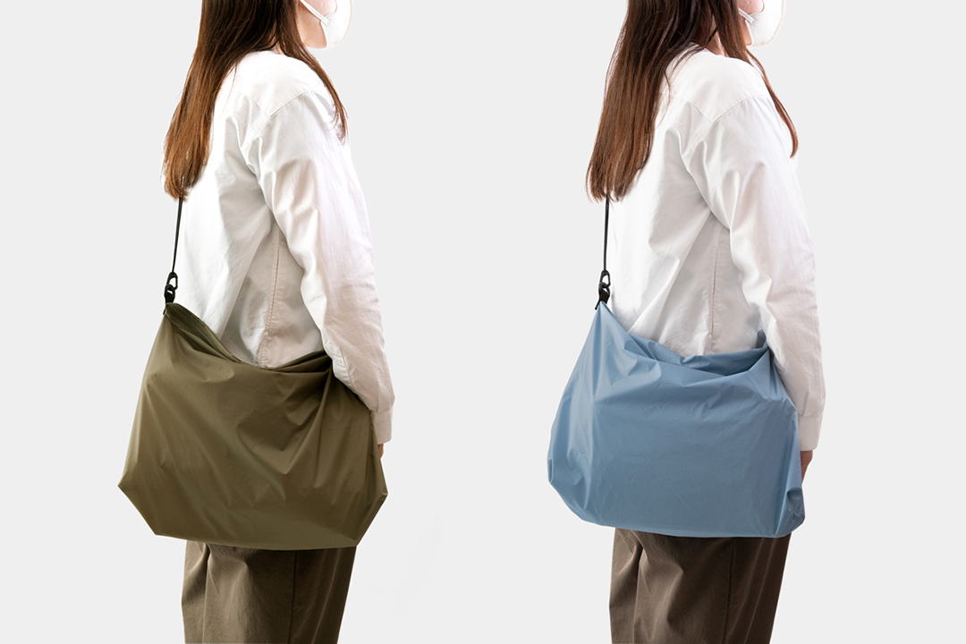 TRAVELER’S FACTORY TO&FRO Shoulder Bag M Size in olive and blue gray modeled by a woman.