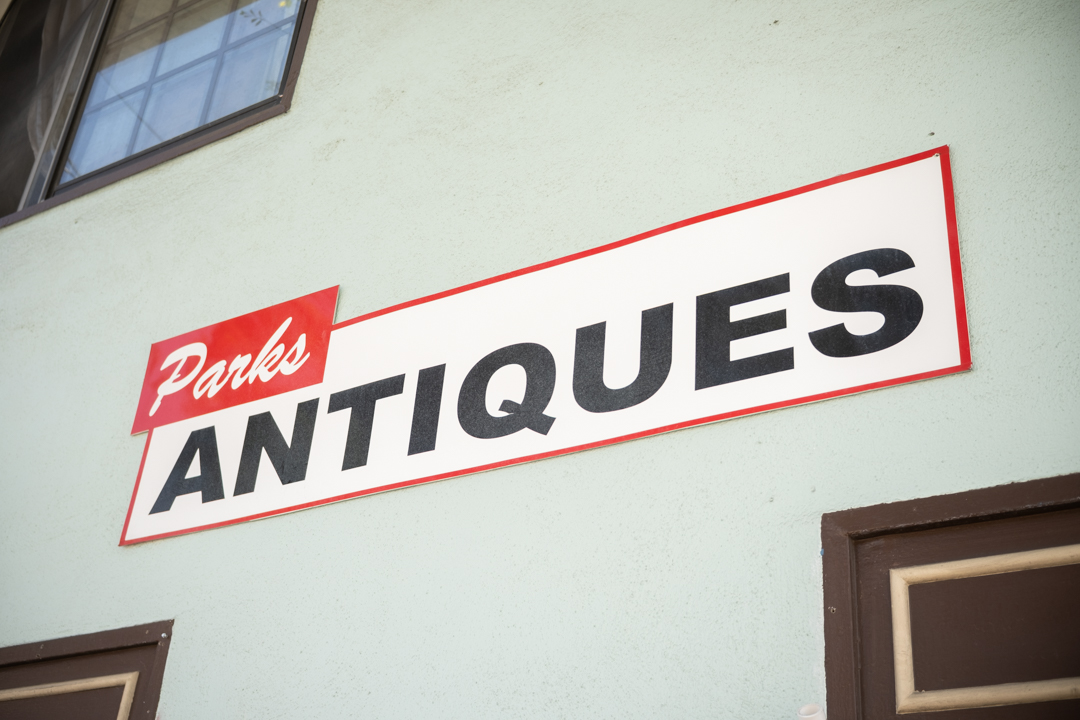 Parks' Antiques sign on the exterior wall of the Parks' Antiques store front.