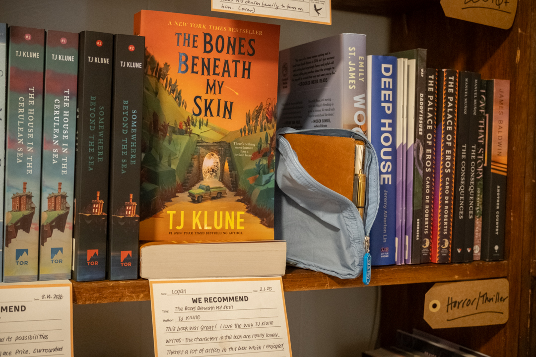 A passport size TRAVELER'S notebook nestled into a bookshelf in the Bel Canto Bookstore.