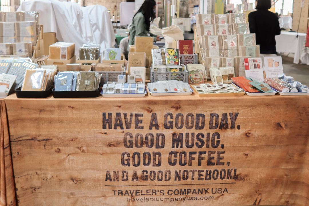 A front view of the TRC USA table filled with TRAVELER'S notebook items at Stationery Fest 2026.