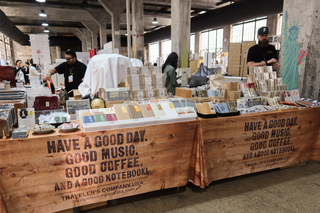 An angled view of the two TRC USA tables filled with TRAVELER'S notebook items at Stationery Fest 2026.