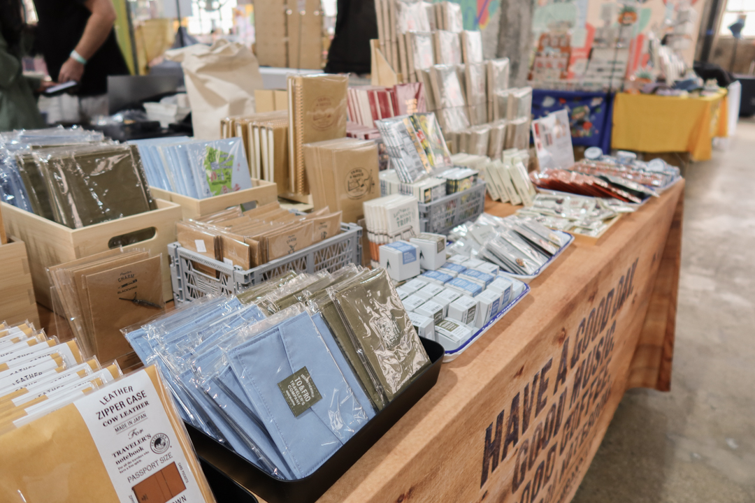 TRAVELER'S notebooks displayed on wooden rack with other TRAVELER'S notebook inserts on the TRC USA table at Stationery Fest 2026.