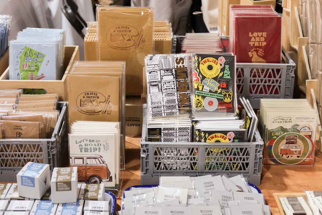 TRAVELER'S notebooks items like the TWELVES limited edition inserts displayed on crates with other TRAVELER'S notebook inserts on the TRC USA table at Stationery Fest 2026.