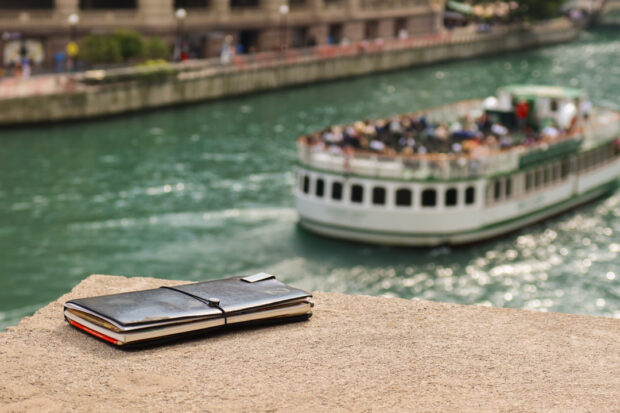 TRAVELER'S notebook next to Chicago riverfront walk.