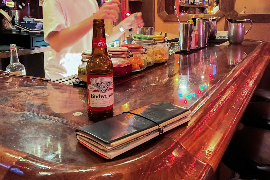 Iijima's TRAVELER'S notebook sitting on a diner counter.
