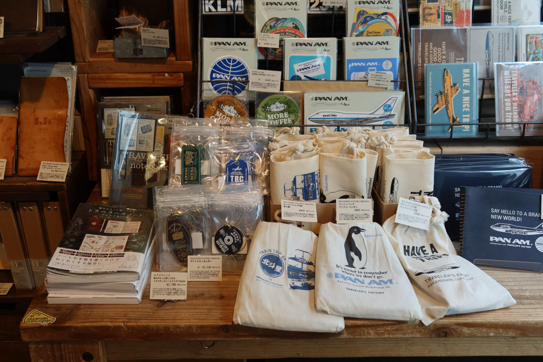 A full display of TRAVELER'S notebook products containing Pan Am and other travel motifs.