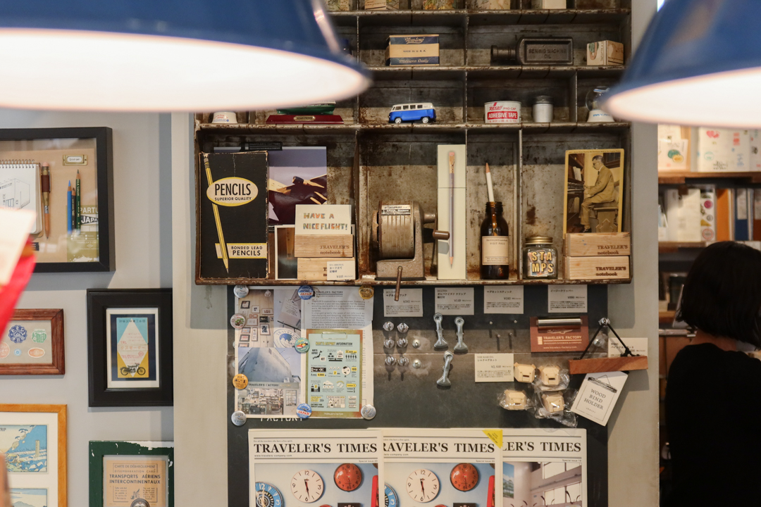 The interior of TRAVELER'S FACTORY STATION filled with TRAVELER'S notebooks, inserts, stationery, and travel memorabilia.