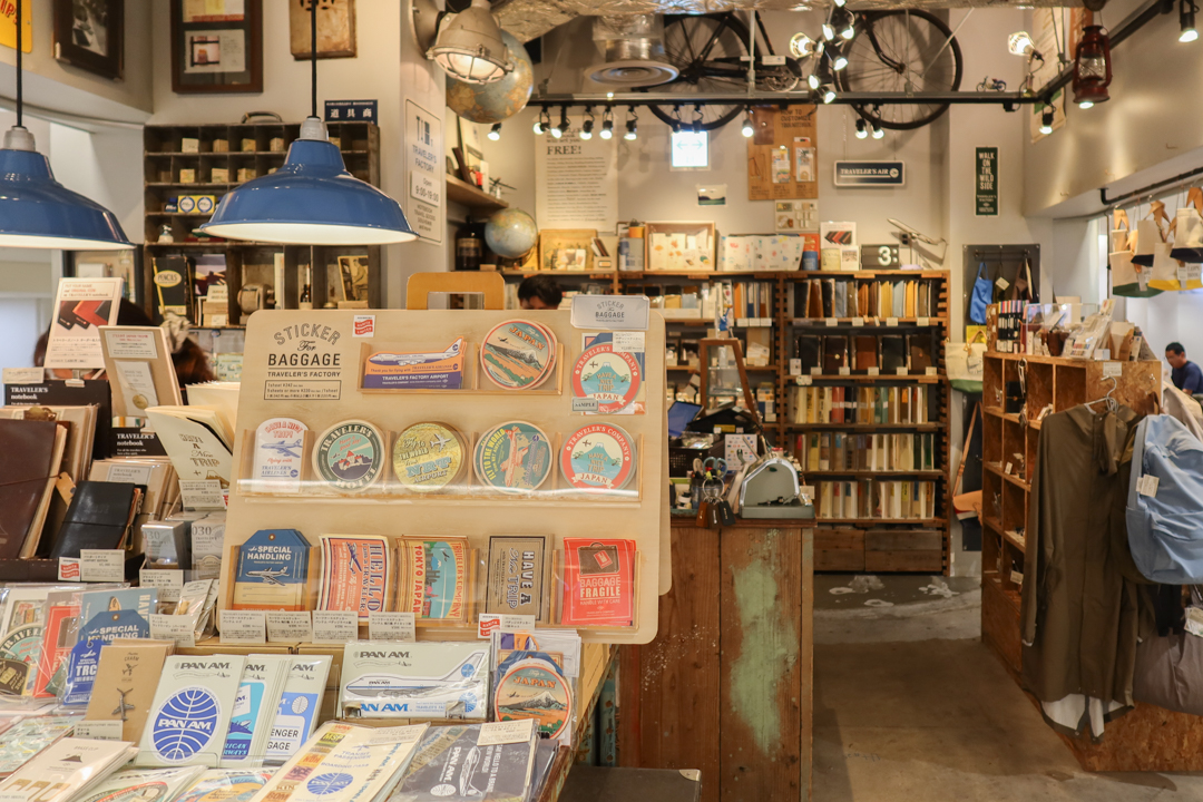 The interior of TRAVELER'S FACTORY STATION filled with TRAVELER'S notebooks, inserts, stationery, and travel memorabilia.