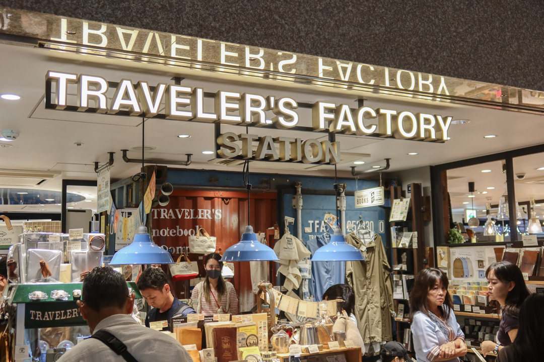 The exterior of TRAVELER'S FACTORY STATION filled with TRAVELER'S notebooks, inserts, stationery, and travel memorabilia.